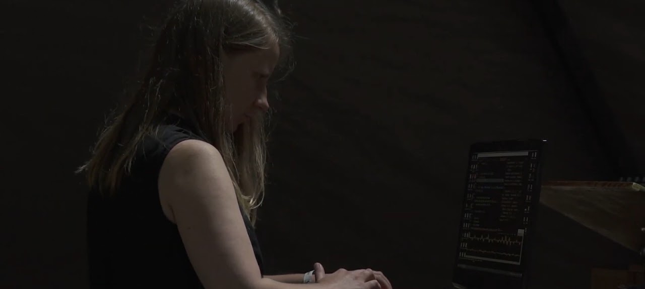 Alise Rancāne performing electronic music with a laptop